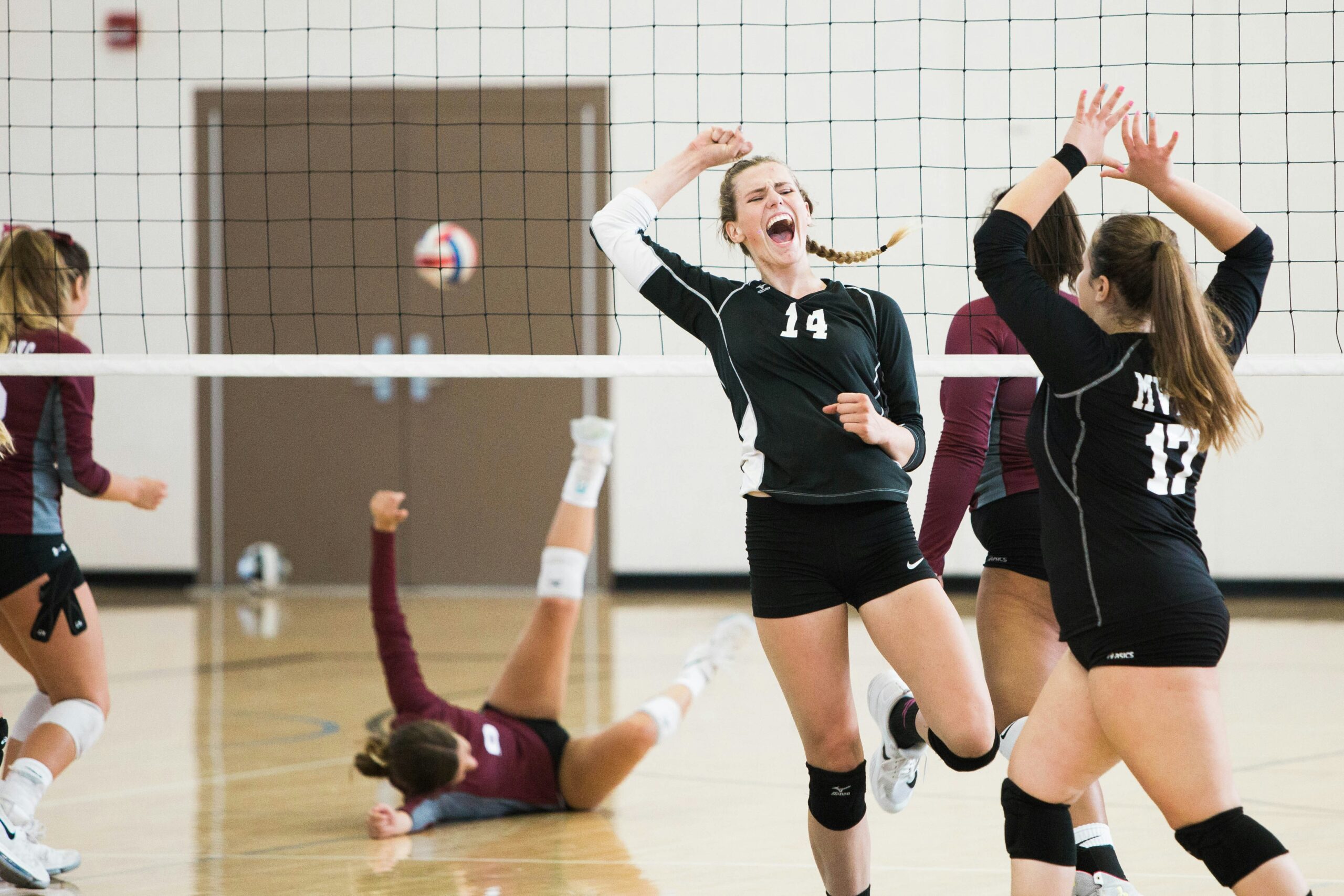 female vollyball player cheering after scoring